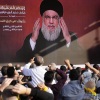 Supporters of the Iranian-backed Hezbollah group raise their fists and cheer as Hezbollah leader Hassan Nasrallah appears via a video link, during a Nov. 3, 2023, rally in Beirut to commemorate Hezbollah fighters who were killed in South Lebanon while fighting against the Israeli forces.