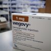 A box of Wegovy, an obesity drug, sit on a pharmacy counter.
