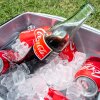 Bottles and cans of Coca-Cola are shown on ice.