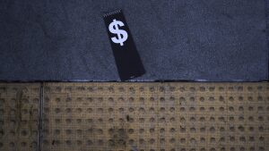 A price tag with a dollar sign lies on the sidewalk outside a Walmart store in La Habra, Calif., Wednesday, April 2.