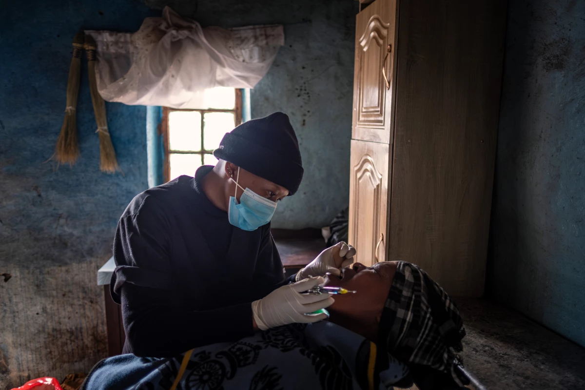 Senate Makhoali of the Lesotho Flying Doctor Service treats a dental patient in the isolated village of Mphooko in the highlands of Lesotho. The village lies several hours on horseback from the nearest road or clinic.
