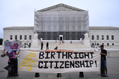 Birthright Citizenship & SCOTUS: Explained Demonstrators outside the Supreme Court holding a sign about birthright citizenship.