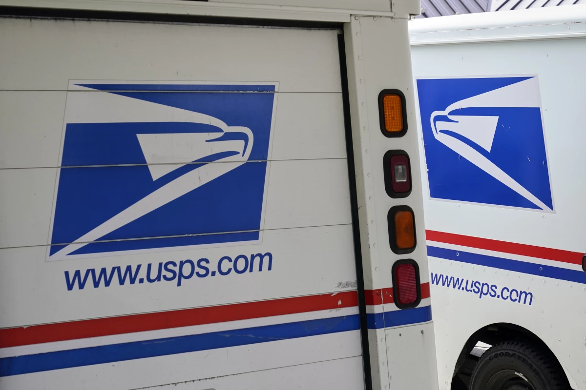 U.S. Postal Service delivery vehicles are parked outside a post office in Boys Town, Neb., on Aug. 18, 2020.