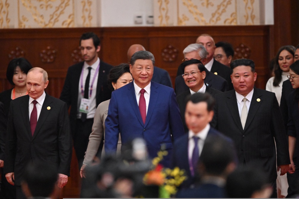 China's President Xi Jinping, center, North Korea's leader Kim Jong Un, right, and Russia's President Vladimir Putin, left, arrive at a reception in the Great Hall of the People, following a military parade marking the 80th anniversary of victory over Japan and the end of World War II, in Beijing on Sept. 3, 2025. (AFP via Getty Images)