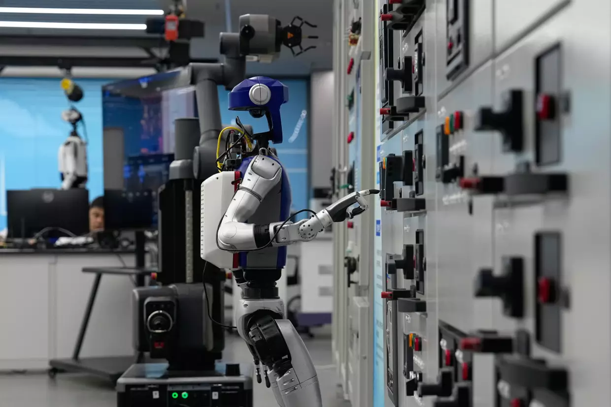 Artificial Intelligence robots demonstrate working on power grid control units during a media organized tour at Guangdong Power Grid Robotics Laboratory in Guangzhou, in southern China's Guangdong province, Thursday, April 16, 2026.