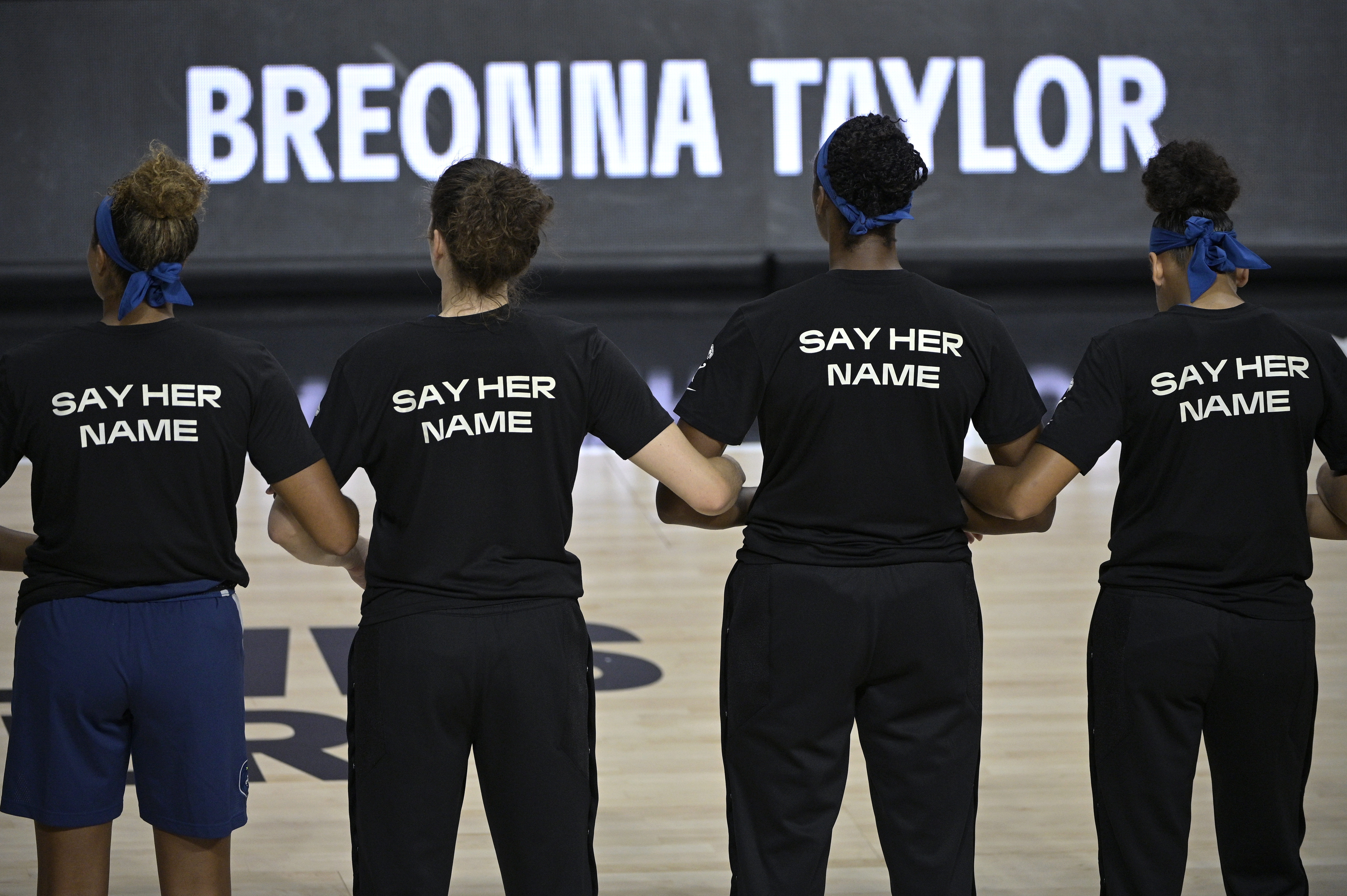 Minnesota Lynx players lock arms during a moment of silence in honor of Breonna Taylor before a game in July 2020.