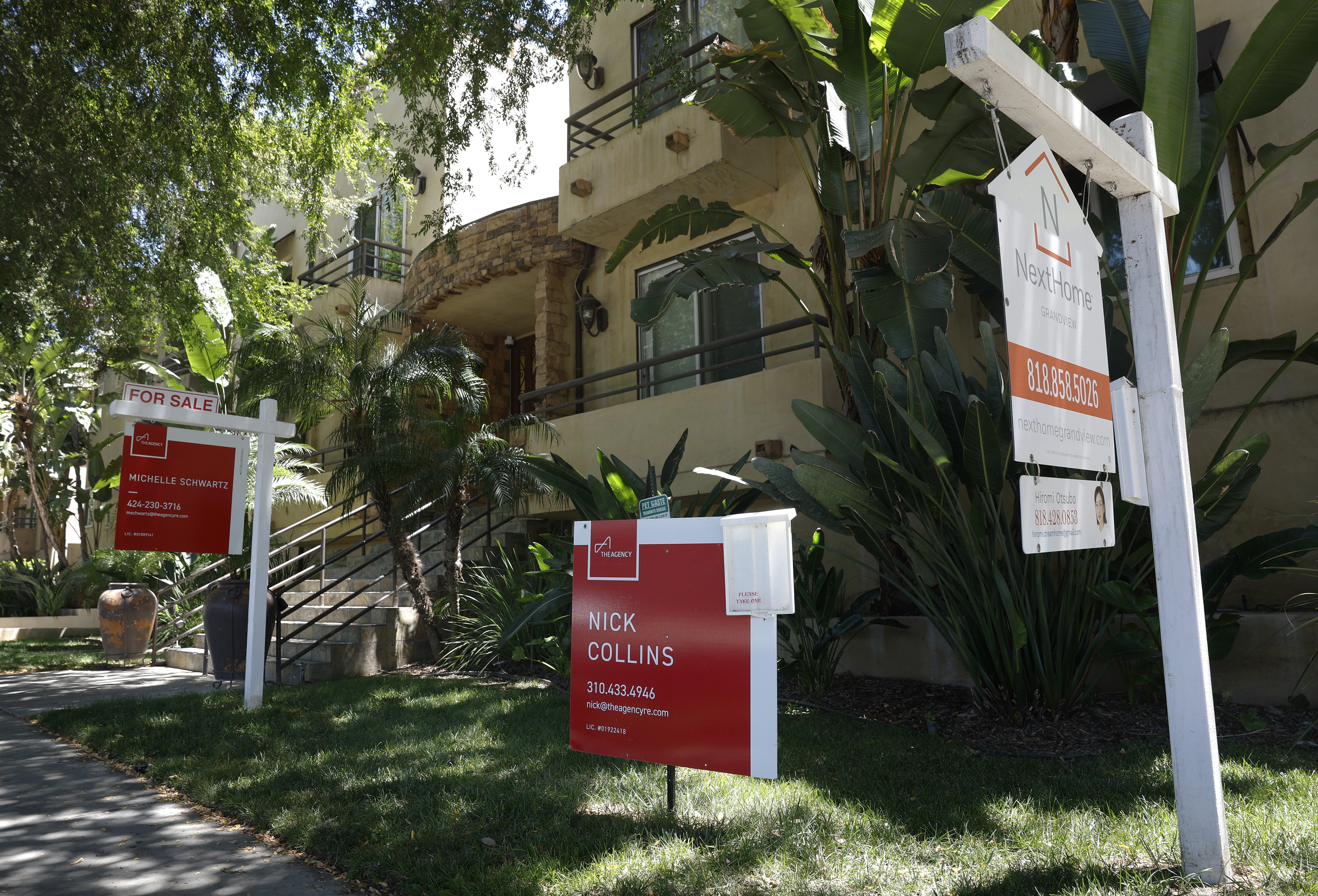 For-sale signs are posted in front of condominiums for sale in July in Los Angeles. A new analysis from the Center for Responsible Lending finds that the average renter household now needs 16 years to save for a down payment and closing costs.