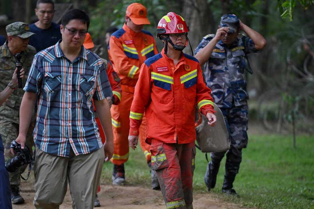 China Fire and Rescue personnel arrive at Trishuli camp after inspecting the tunnel site in Rasuwa, in the aftermath of flash floods in Nepal's Nuwakot district on August 31, 2026. Rescuers struggled on August 31 through mud and debris for a sixth day, as the number of missing people soared to nearly 5,000 since tsunami-like glacial floods roared down from the China-Nepal border, creating an "unimaginable" disaster.