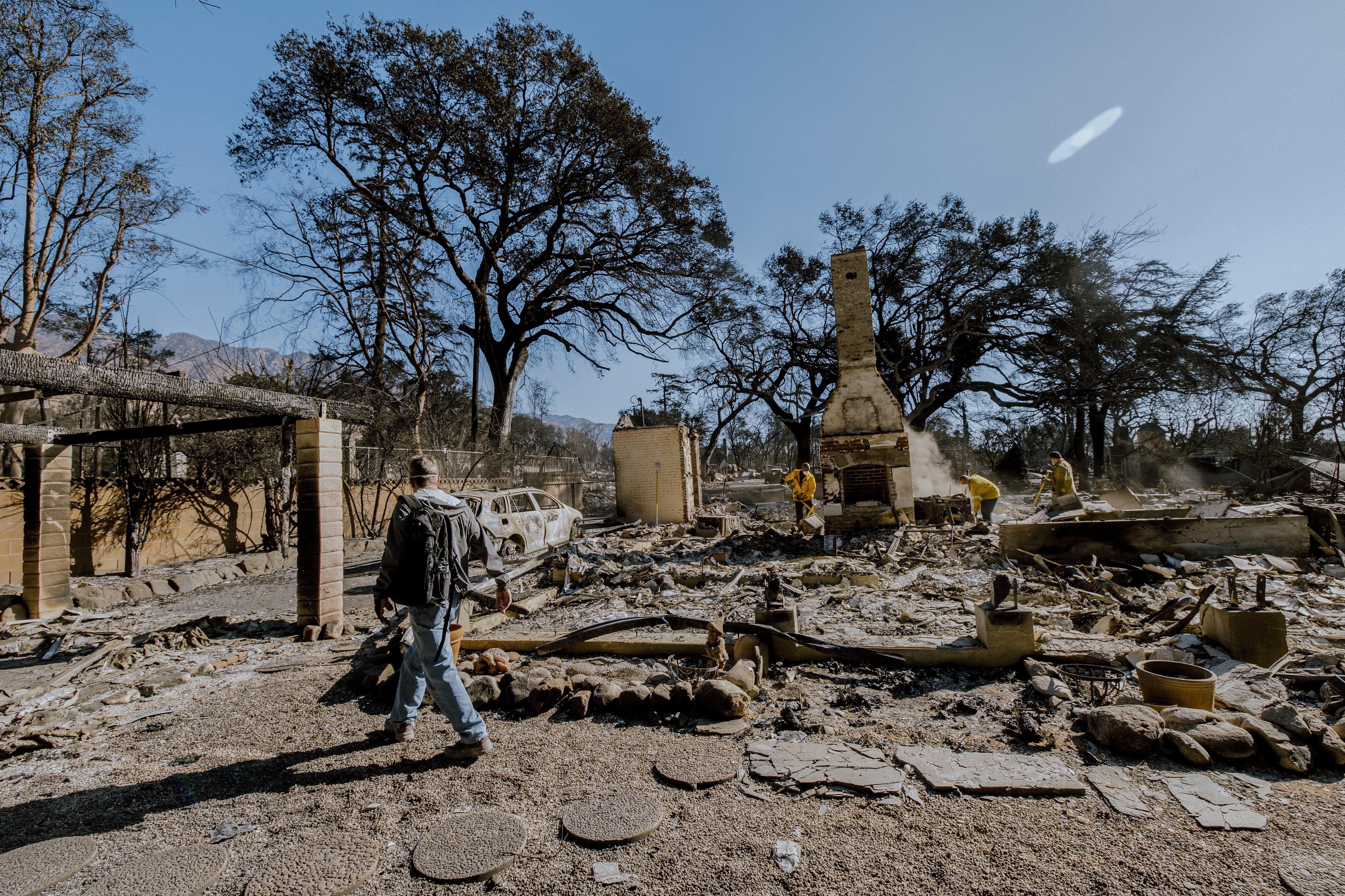 A man surveys the charred remains of his home, destroyed in the Eaton Fire on Jan. 8. The house, built in 1902 and owned by his family for generations, was slated for a remodel to pass down to the next generation.