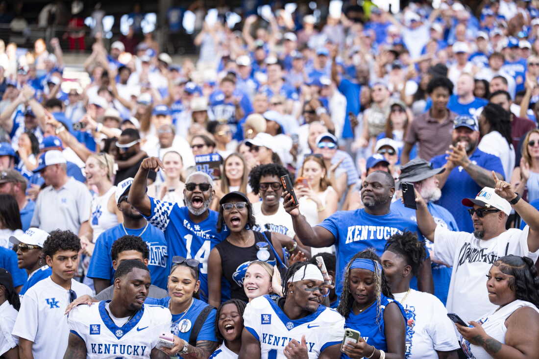 University of Kentucky Wildcats fans, wearing blue and white, celebrate after their team beat the Texas A&M Aggies at Kyle Field stadium, in College Station, Texas, on September 19.
