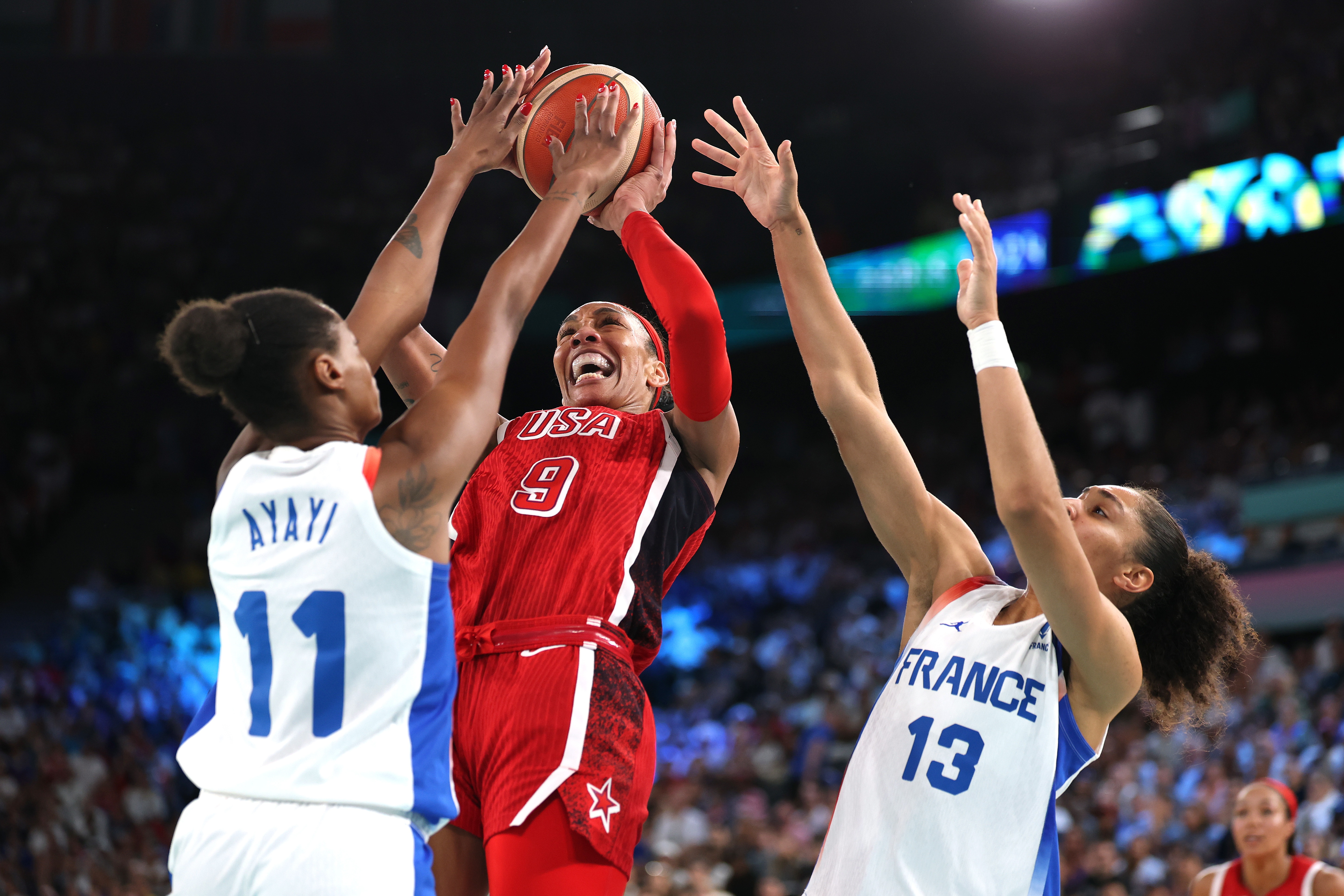 A'Ja Wilson #9 of Team United States shoots between Valeriane Ayayi (L) and Janelle Salaun of Team France during the Women's Gold Medal game Sunday at the Paris Olympics. (Getty Images)