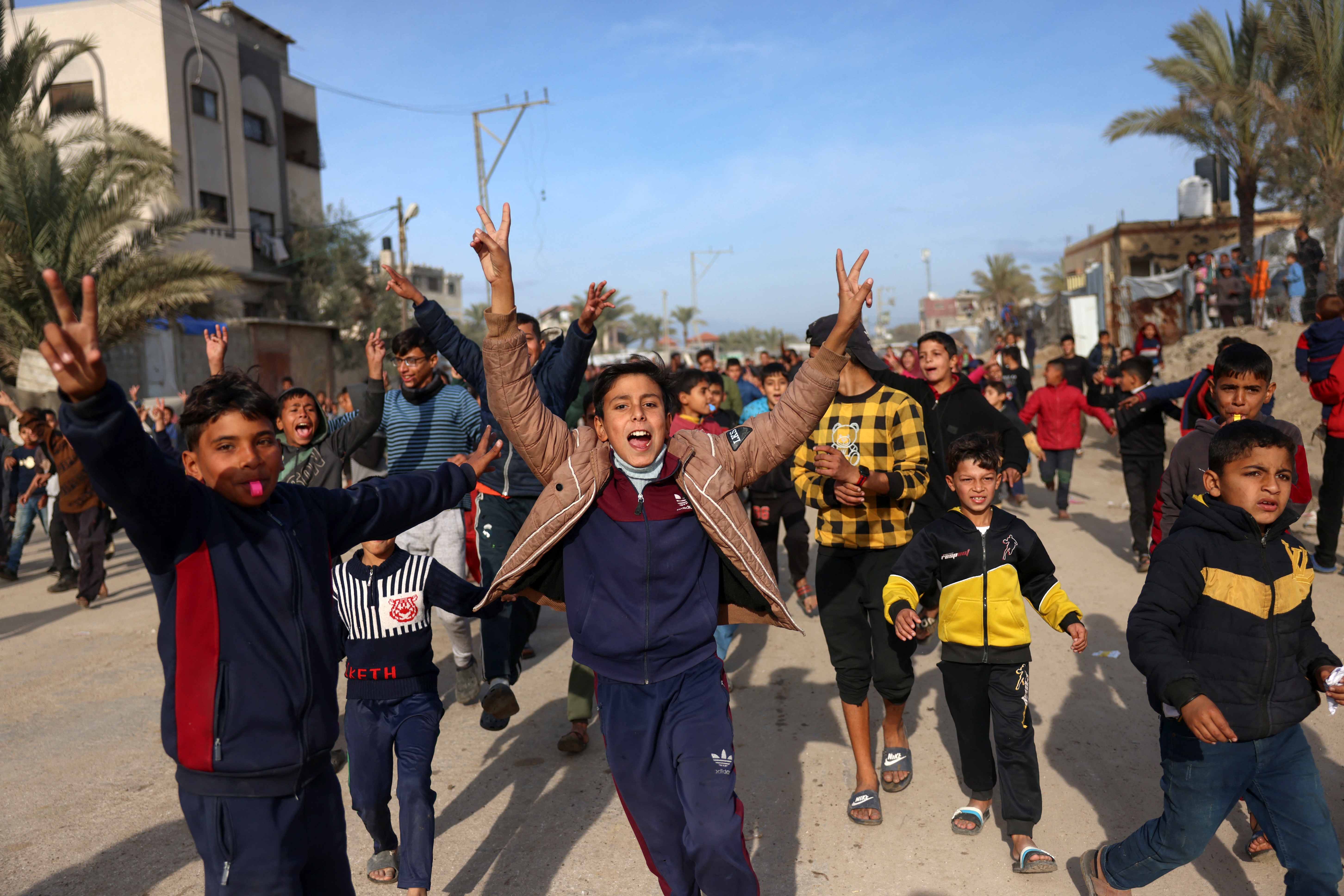 Children cheer in Nuseirat in the central Gaza Strip on January 19, 2025, shortly before a ceasefire deal in the war between Israel and the Palestinian militant group Hamas was implemented.