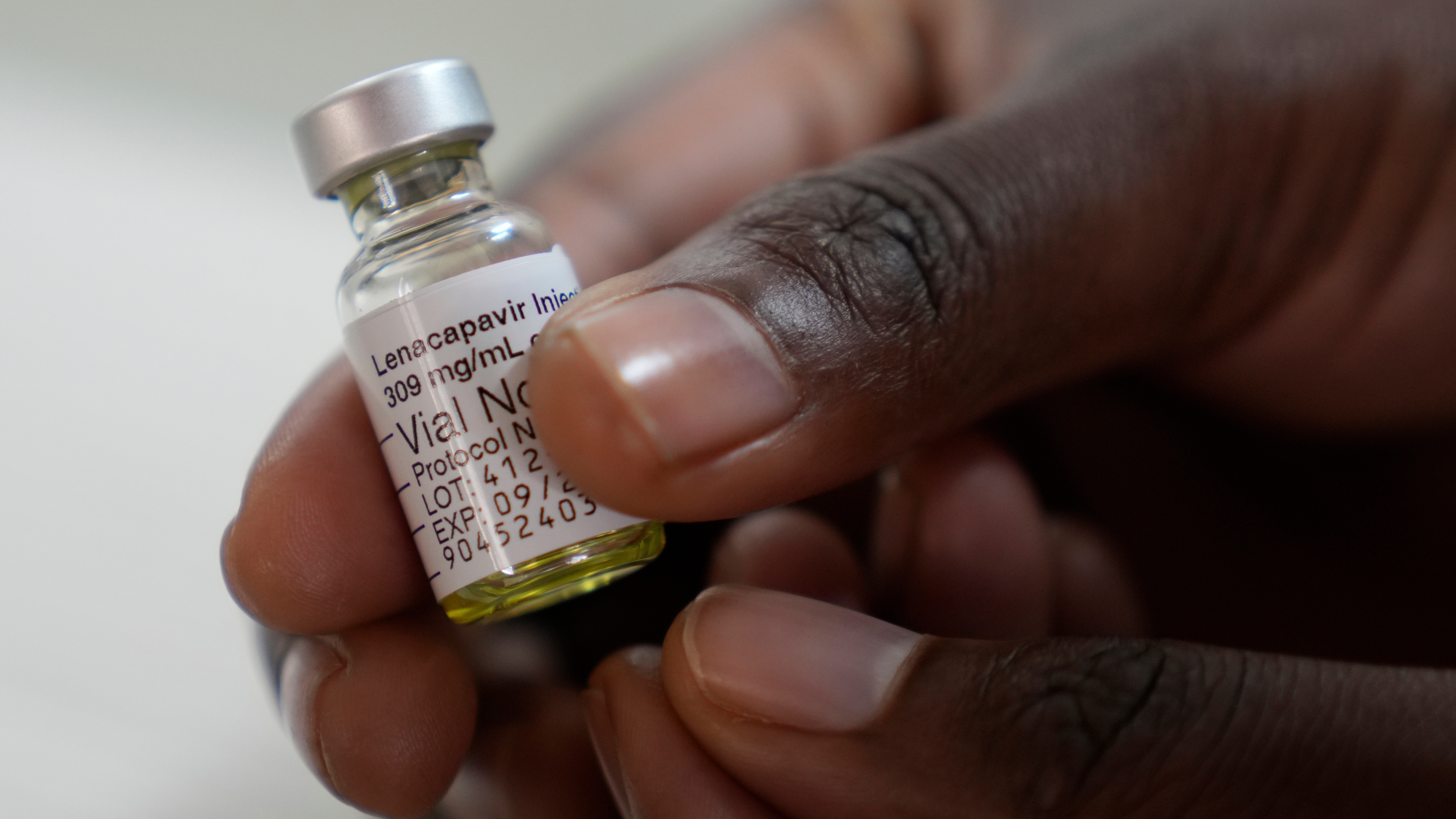 A pharmacist holds a vial of lenacapavir, described as a "breakthrough" HIV prevention drug, at a research site in South Africa.