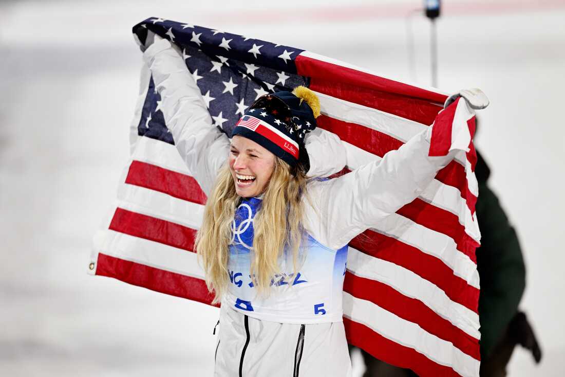 Bronze medallist, Jessie Diggins of Team United States celebrates with a flag during the Women's Cross-Country Sprint Free Final flower ceremony on Day 4 of the Beijing 2022 Winter Olympic Games at The National Cross-Country Skiing Centre on February 08, 2022 in Zhangjiakou, China. (Photo by Matthias Hangst/Getty Images)