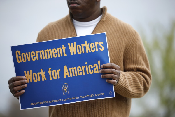 A union supporter holds a sign at a press conference on federal workforce rights outside the U.S. Capitol on March 28, 2025 in Washington, D.C. Lawmakers and union leaders spoke out against President Donald Trump's executive order ending collective bargaining with federal labor unions.