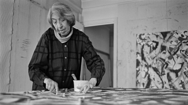 A black-and-white photo of Lee Krasner at work in 1981.