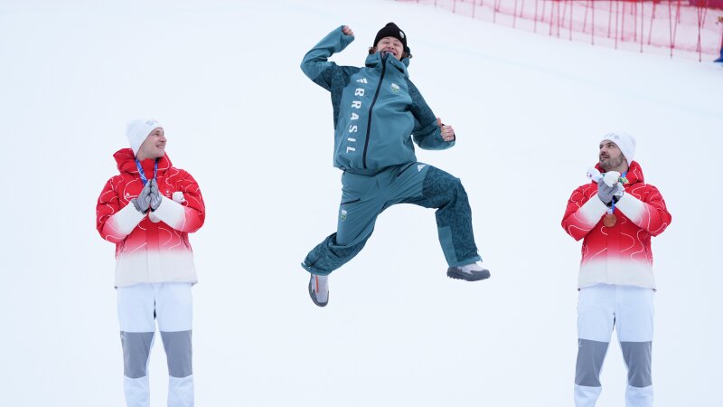 Brazil's Lucas Pinheiro Braathencentercelebrates winning a gold medal for an alpine skimen's giant slalom raceas silver medalist Switzerland's Marco Odermattrightand bronze medalist Switzerland's Loic Meillard applaudat the 2026 Winter Olympicsin BormioItalySaturdayFeb. 142026.