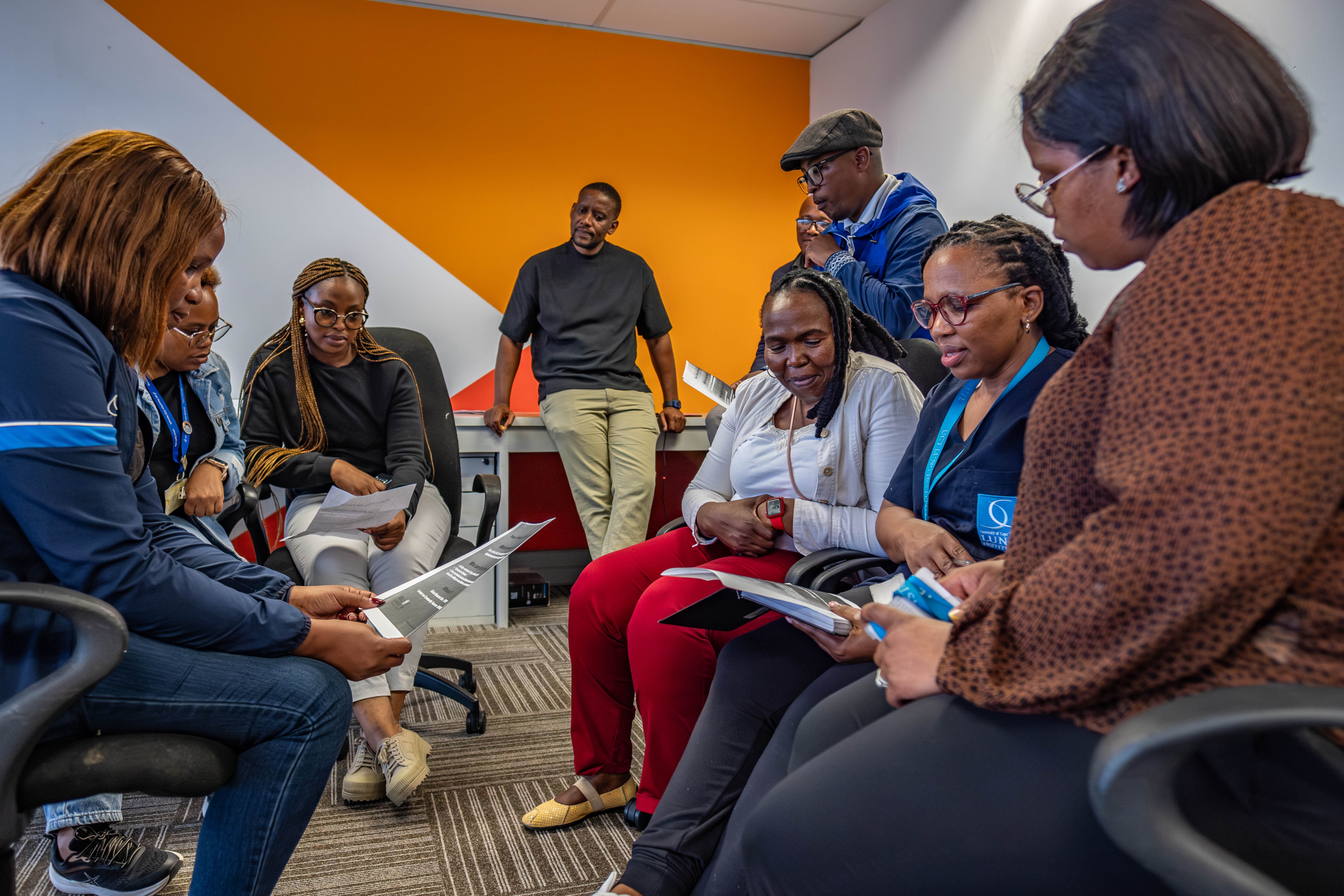 Health workers including community liaison officer Amelia Mfiki (far left) discuss the recruitment of participants for a new HIV vaccine trial in the township of Philippi Village in Cape Town, South Africa.