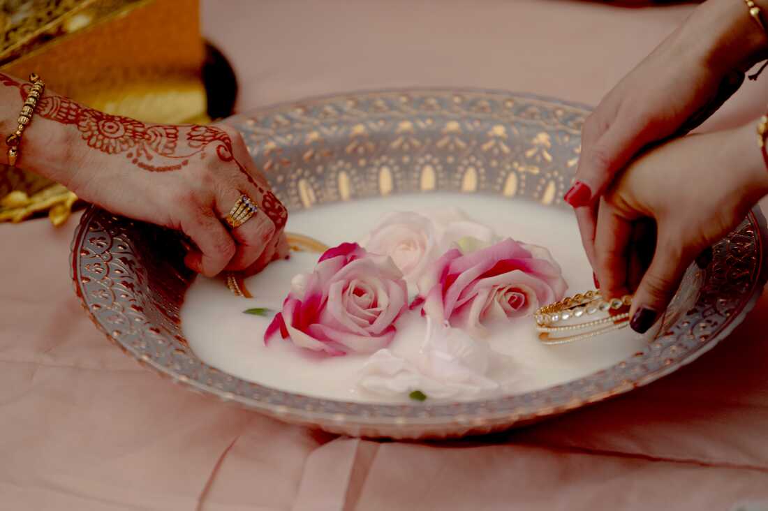The Chooda ceremony is a central Sikh pre-wedding ritual celebrating the bride’s transition into married life. The bride’s maternal uncle and aunt gift her red and ivory bangles, which are first dipped in a mixture of milk and rose petals to cleanse and bless them. This act symbolizes fertility, prosperity, and spiritual protection, while family members gather to pray for the bride’s happiness and success in her new journey.