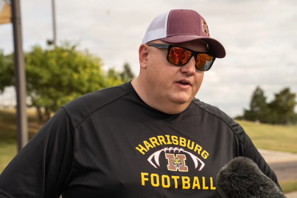 At a Harrisburg High School football tailgate, when asked where he gets his news, Aaron Zahn shares that he mostly watches Fox.