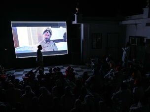 This photograph taken on July 15 shows villagers watching the film <em>Satluj</em> during a community-led screening at the Gurudwara Singh Sabha in Punjab's Gurdaspur city. Across Punjab, Sikh religious bodies and political groups have been hosting <em>Satluj</em> film screenings in temple courtyards, community halls and village squares with viewer numbers swelling.
