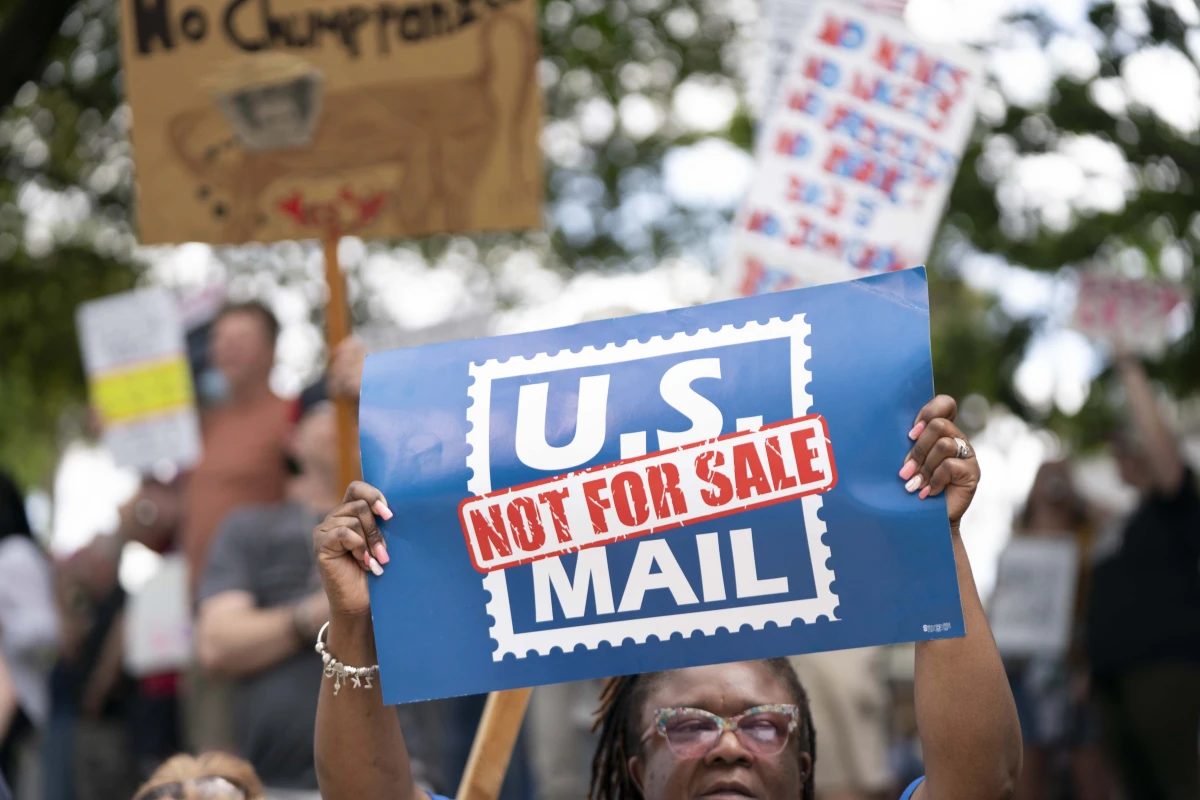A demonstrator holds a sign that says 'U.S. MAIL NOT FOR SALE' during an April protest in Columbia, S.C.