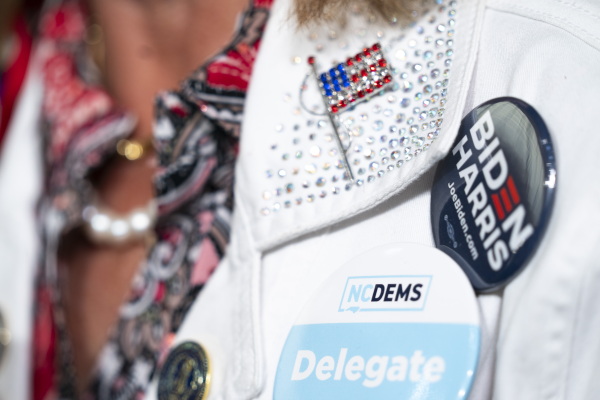 A woman wears a North Carolina delegate button during a campaign event with Vice President Harris on July 11, 2024 in Greensboro, N.C.