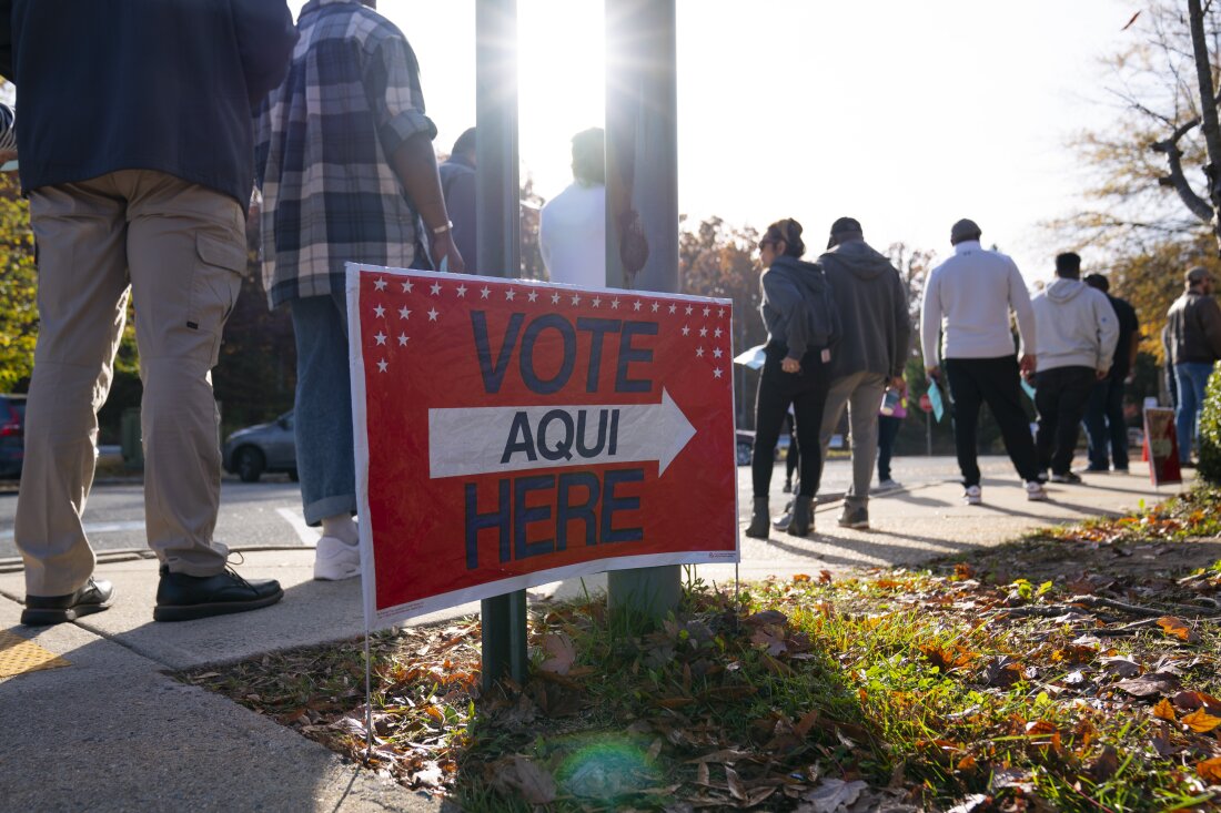 Voters line up outside of an early voting location for the 2022 midterm election in Woodbridge, Va.