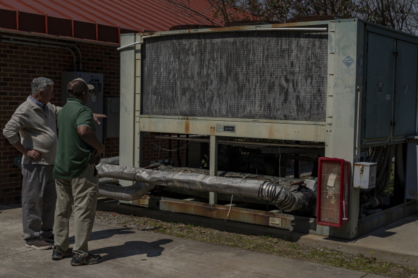 A large AC unit at Trinity Woods, originally installed in 1993, shows severe rust damage. The unit has since been replaced, but aging infrastructure remains a concern at the subsidized senior living center in Emporia, Va., on Friday, Feb. 28, 2025. Photographer: Carlos Bernate for NPR.
