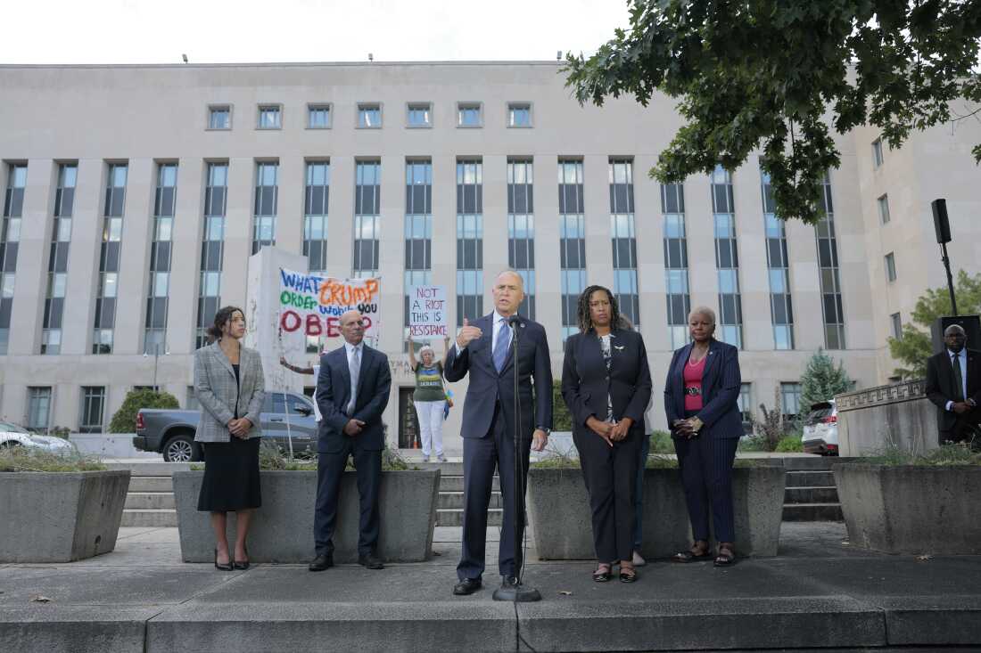 Washington, D.C. Attorney General Brian Schwalb and Mayor Muriel Bowser speak outside of a federal courthouse Friday following a court hearing. Schwalb filed a lawsuit against the federal government claiming that the Trump Administration overstepped its authority when the federal government took over the Metropolitan Police Department and replaced the chief of police with a federal official.
