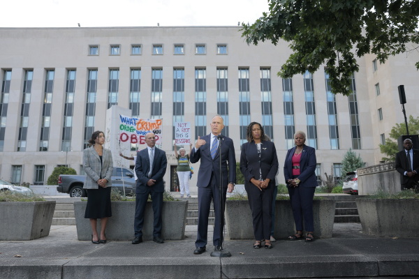 Washington, D.C. Attorney General Brian Schwalb and Mayor Muriel Bowser speak outside of a federal courthouse Friday following a court hearing. Schwalb filed a lawsuit against the federal government claiming that the Trump Administration overstepped its authority when the federal government took over the Metropolitan Police Department and replaced the chief of police with a federal official.