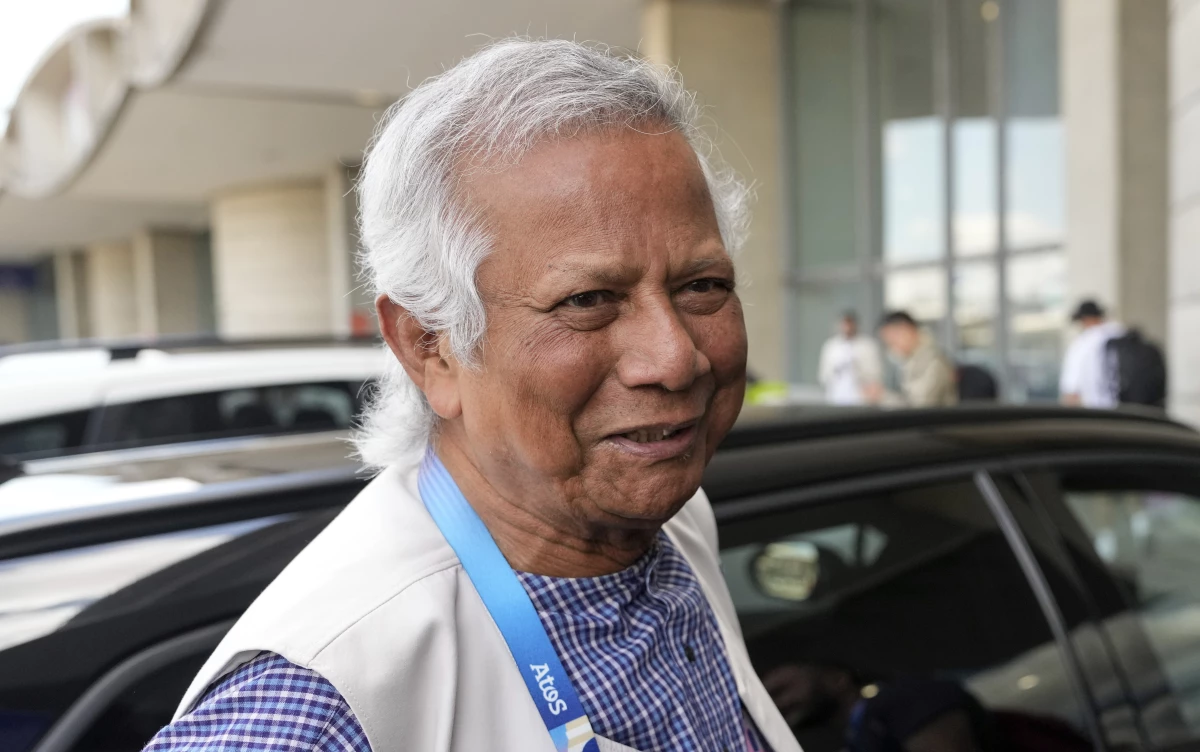 Nobel laureate Muhammad Yunus smiles upon his arrival at Charles de Gaulle's airport in Roissy, north of Paris, on Wednesday.