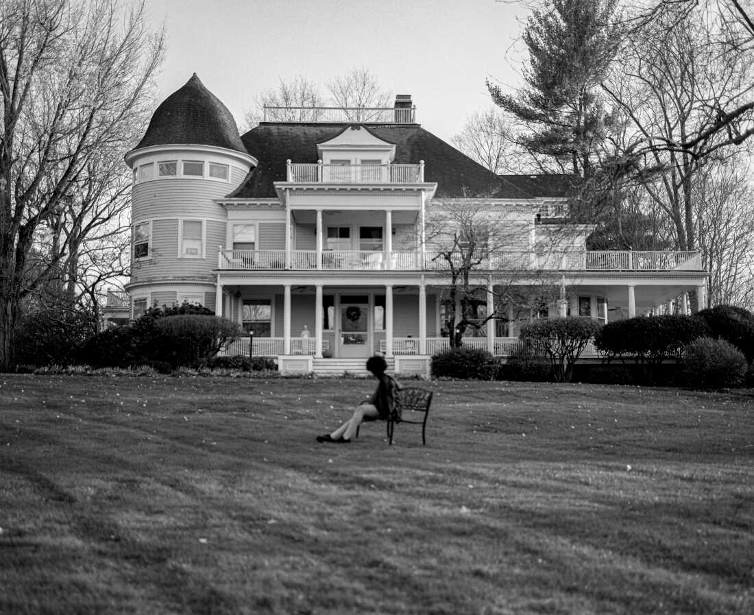 Mikaela Gumbel sits on a bench in front of her grandmother’s home in Westchester County, N.Y.