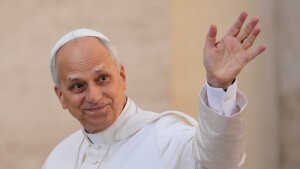 Pope Leo XIV waves as he arrives for his weekly general audience in St. Peter's Square at the Vatican on Oct.1, 2025.