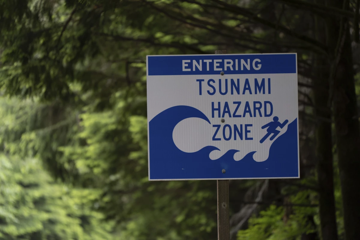 A sign warning drivers that they are entering a tsunami hazard zone is displayed along U.S. Route 101 also known as the Oregon Coast Highway north of Lincoln City, Ore., on June 14, 2024.