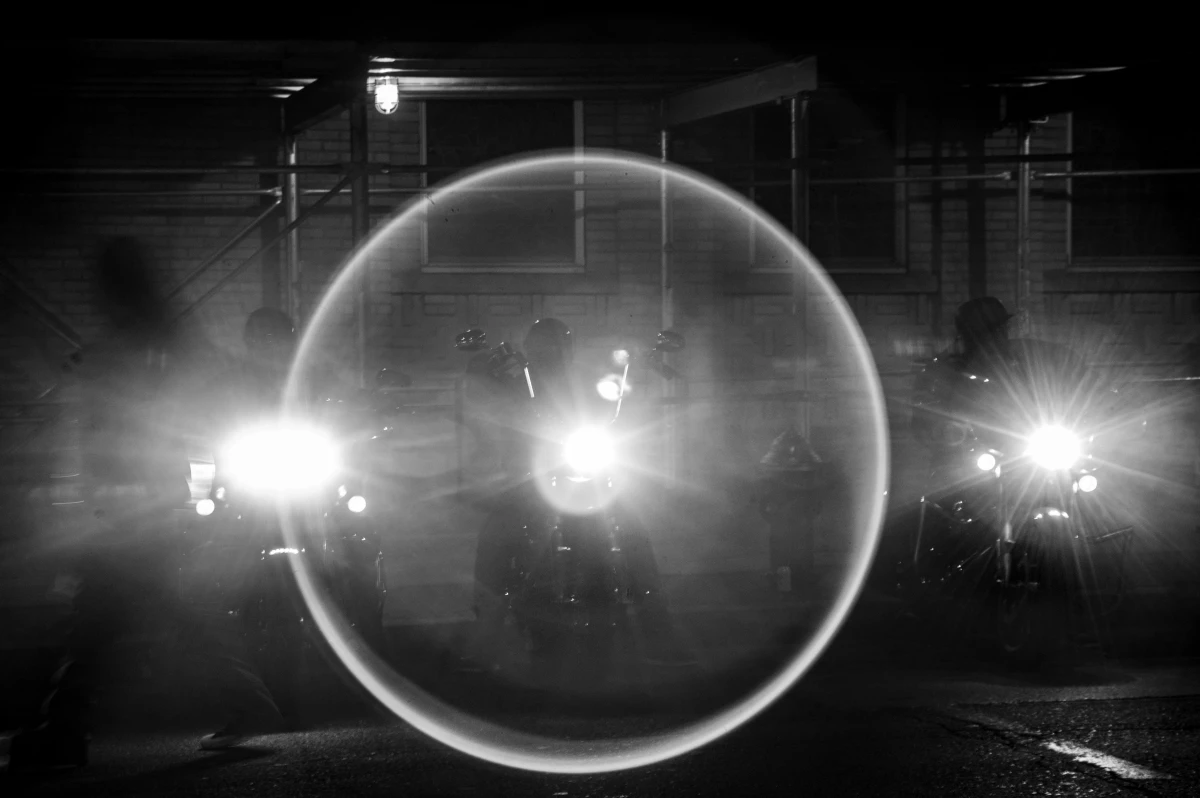 The Aztec Rebels start their motors before departing on a night ride in the Bronx.