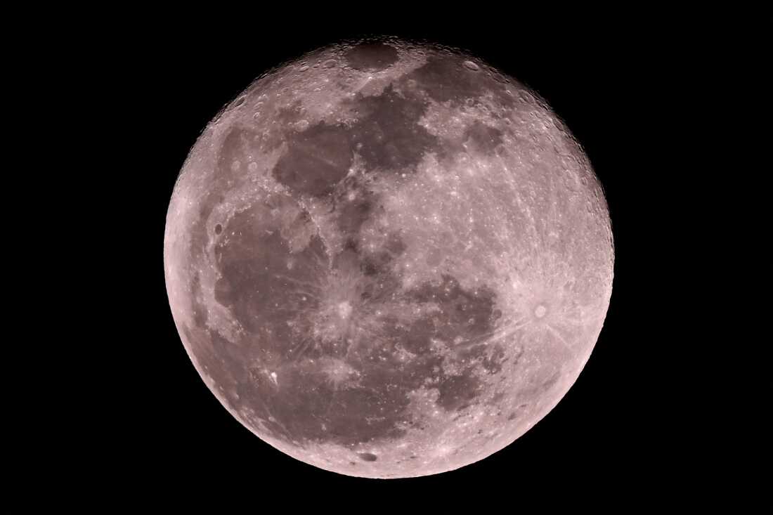The moon shines over the Marrara Oval ground during the T20 international cricket match between Australia and South Africa in Darwin on Aug. 10, 2025.