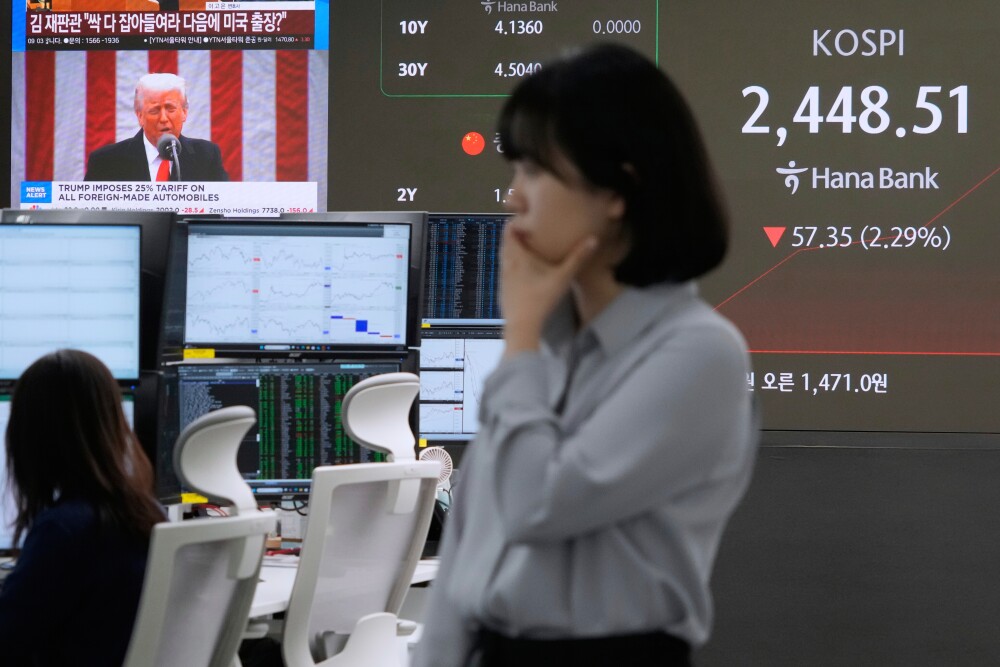 U.S. President Donald Trump is seen on a screen as a currency trader works at the foreign exchange dealing room of the KEB Hana Bank headquarters in Seoul, South Korea, Thursday, April 3, 2025. (AP)