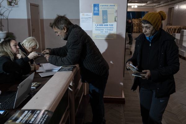 People register to receive humanitarian aid in the battered coal mining town of Dobropillya, Ukraine, on Oct. 17.