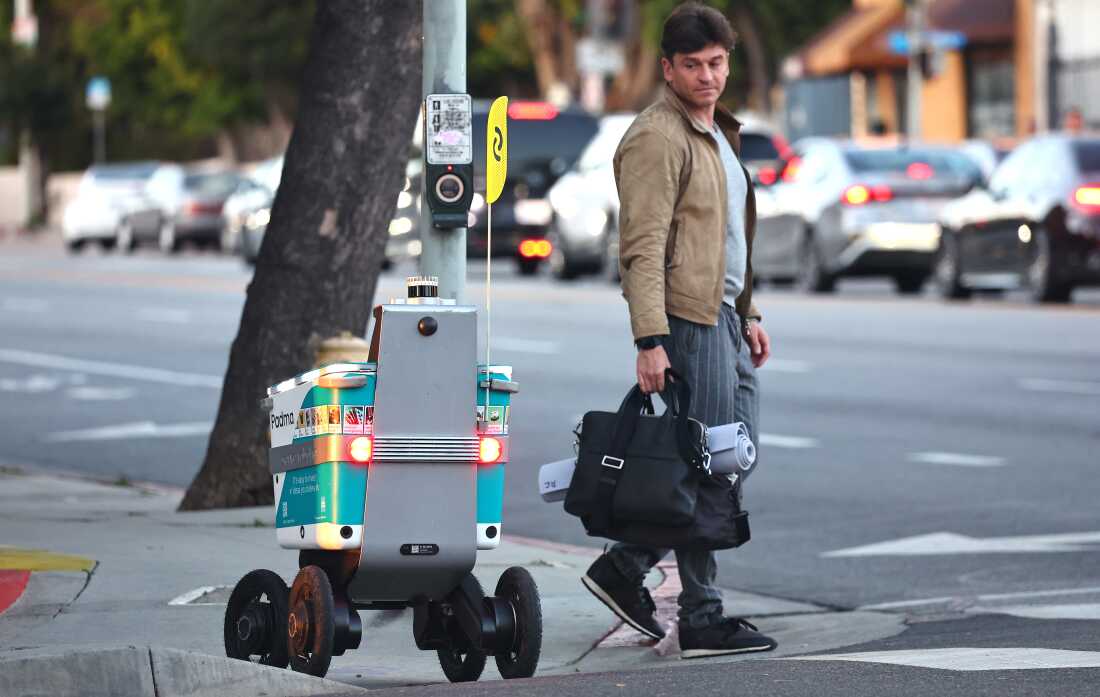 A Serve Robotics autonomous delivery robot, which utilizes AI and is emissions-free, crosses a crosswalk onto a sidewalk on March 19, 2024 in West Hollywood, California.