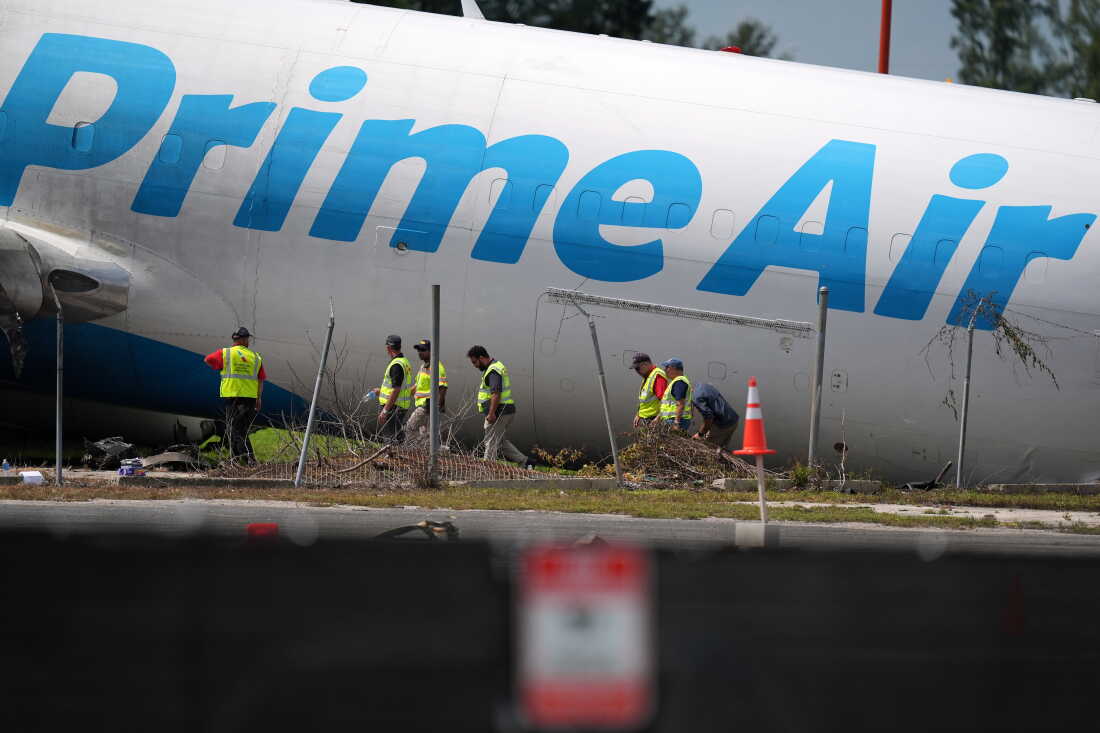 Workers inspect an Amazon cargo plane two days after it overshot a runway at Miami International Airport, Tuesday, Sept. 8, 2026, in Miami.