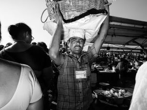 A basket man carries a load of fish through Kasimedu Fishing Harbour in Chennai, India. Nearly 1,000 of the roughly 5,000 workers carry fish this way. They're mostly migrant laborers who earn about $5 a day.