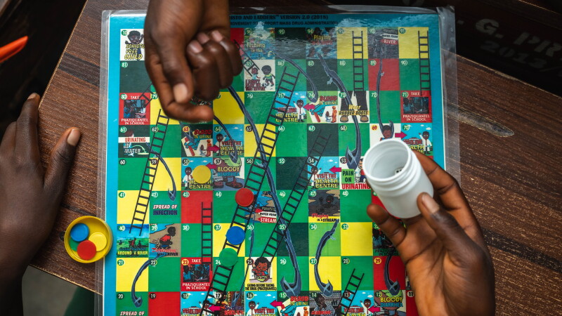 The game "Schisto & Ladders" is introduced to students in an elementary school in a part of Nigeria where the neglected tropical disease schistosomiasis, spread by parasitic worms, affects many residents. This version of the classic "Chutes & Ladders" games aims to teach children how to avoid getting infected — and details of the treatment for those who catch it. 