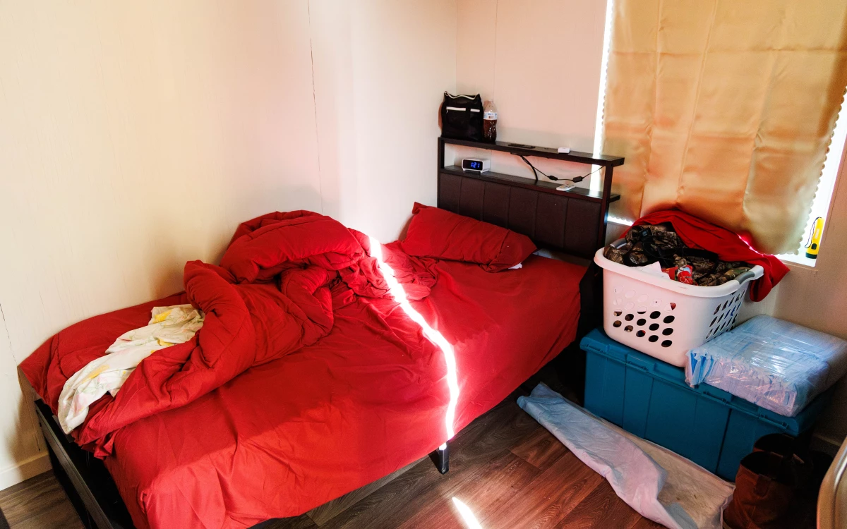 Matthew Stone's sleeping cabin has a bed, an alarm clock and a place for his belongings.