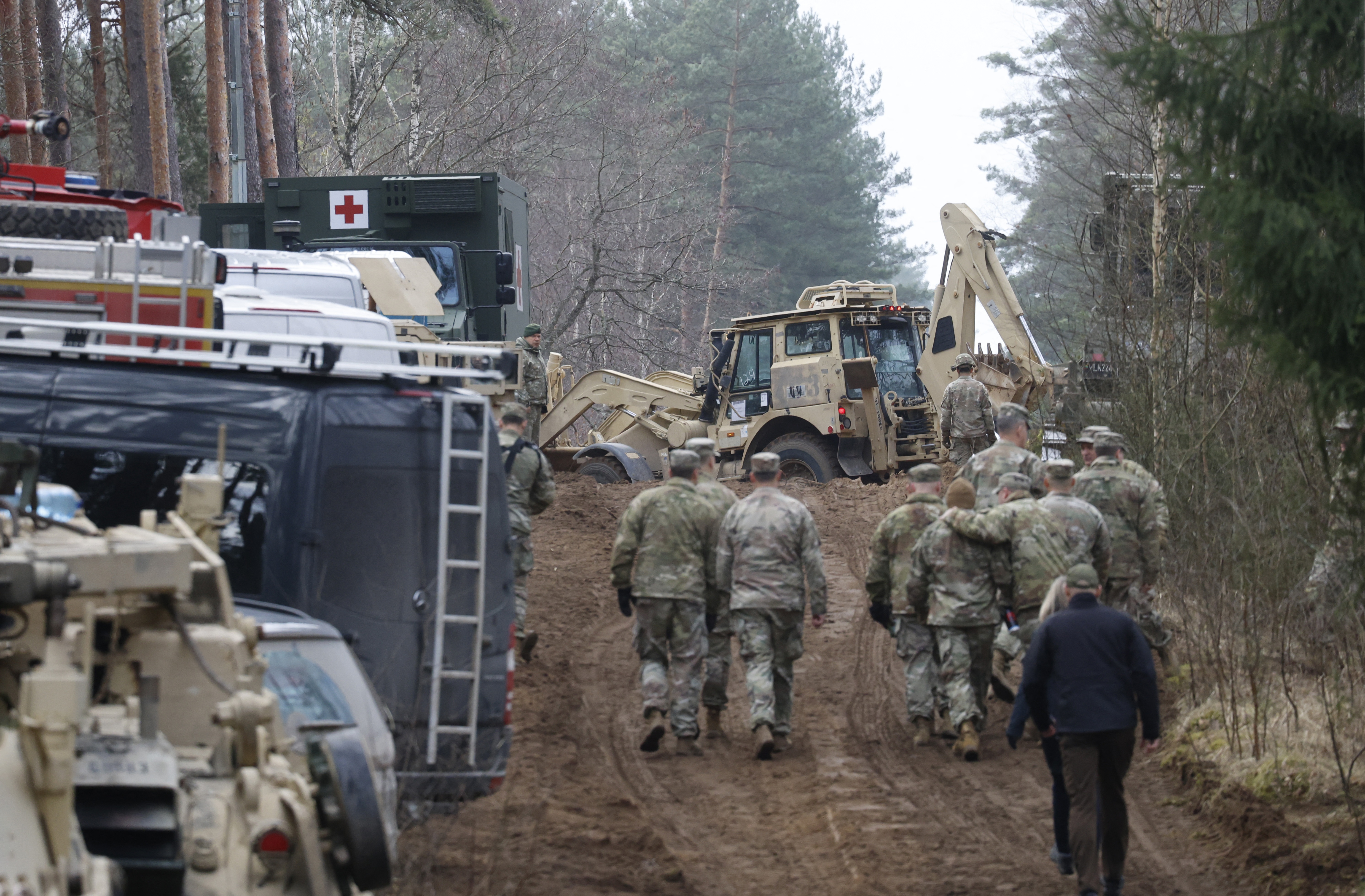 Military personnel work at the site of a rescue operation for missing U.S. soldiers at Pabradė training ground, in Lithuania, on Friday.