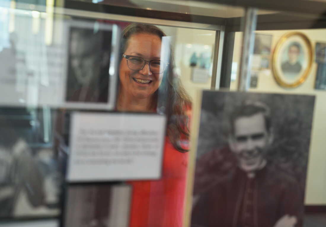 Bonnie Engstrom, who believes the late Archbishop Fulton Sheen helped save her son's life after he was born in 2010 without a pulse, looks at a photo of Sheen on display at the Sheen Museum in Peoria, Ill., on July 16, 2026. (AP Photo/Jessie Wardarski)