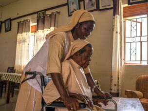Sister Mary Consolata Nakawoojwa wheels an elderly nun to her room at the Little Sisters of St. Francis premises in Nkokonjeru, Uganda on May 12, 2026.