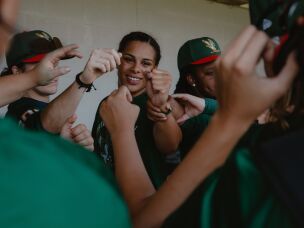 Robinson (center) fist bumps her teammates at the conclusion of a preseason scrimmage prior to the WPBL's opening weekend on Thursday, July 30, in Springfield, Ill.
