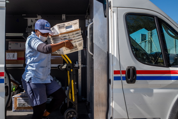 A U.S. Postal Service employee unloads mail at a facility in 2022 in Houston.