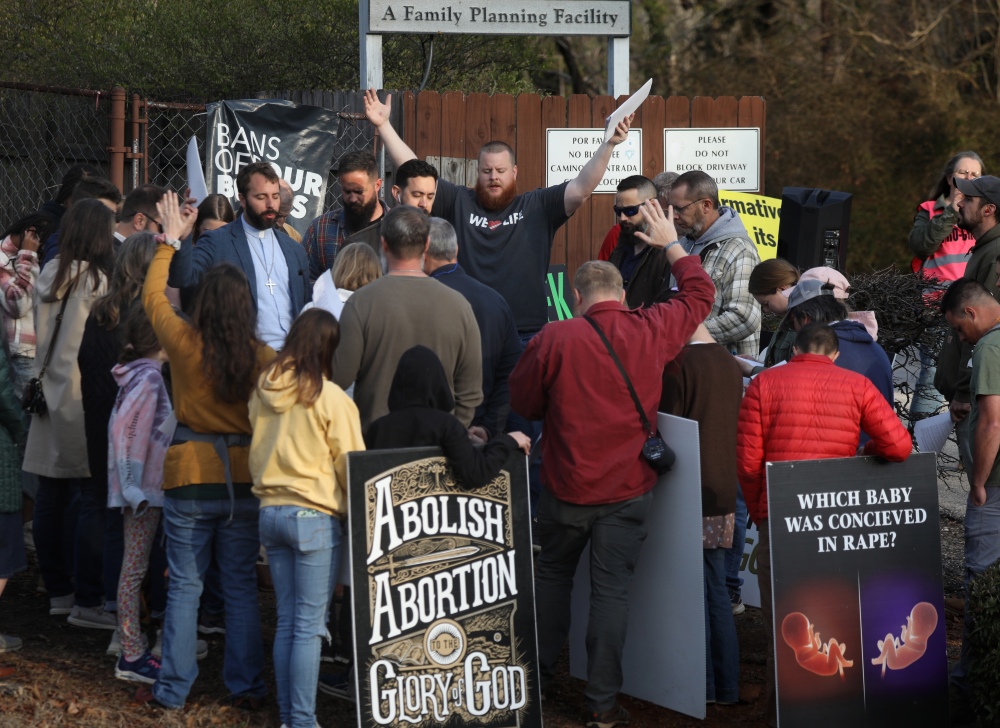 Anti-abortion activists pray and protest in front of the Greenville Women's Clinic in Greenville, S.C., in March. (Jim Urquhart for NPR)
